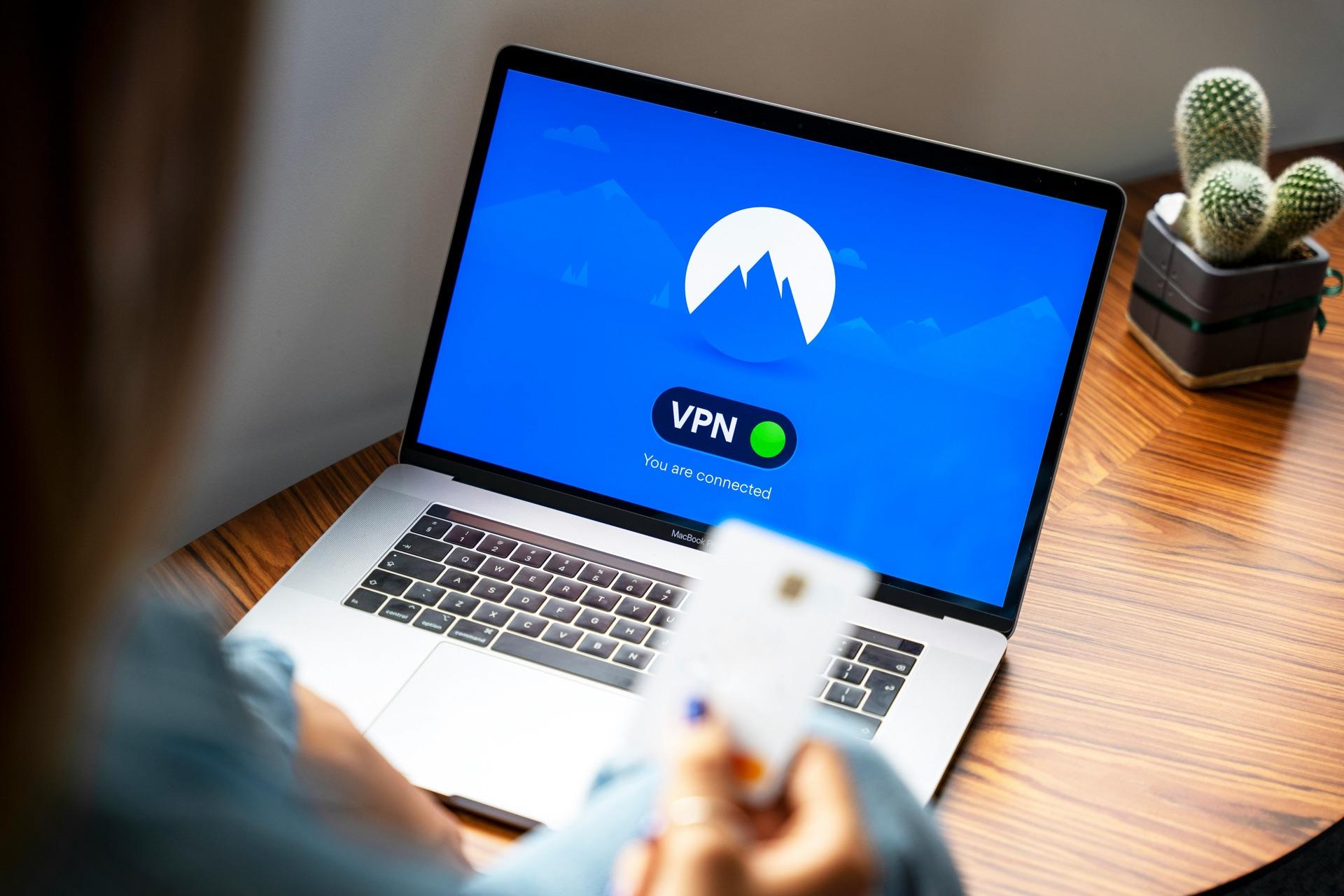 A business owner securing a remote connection over VPN on a laptop