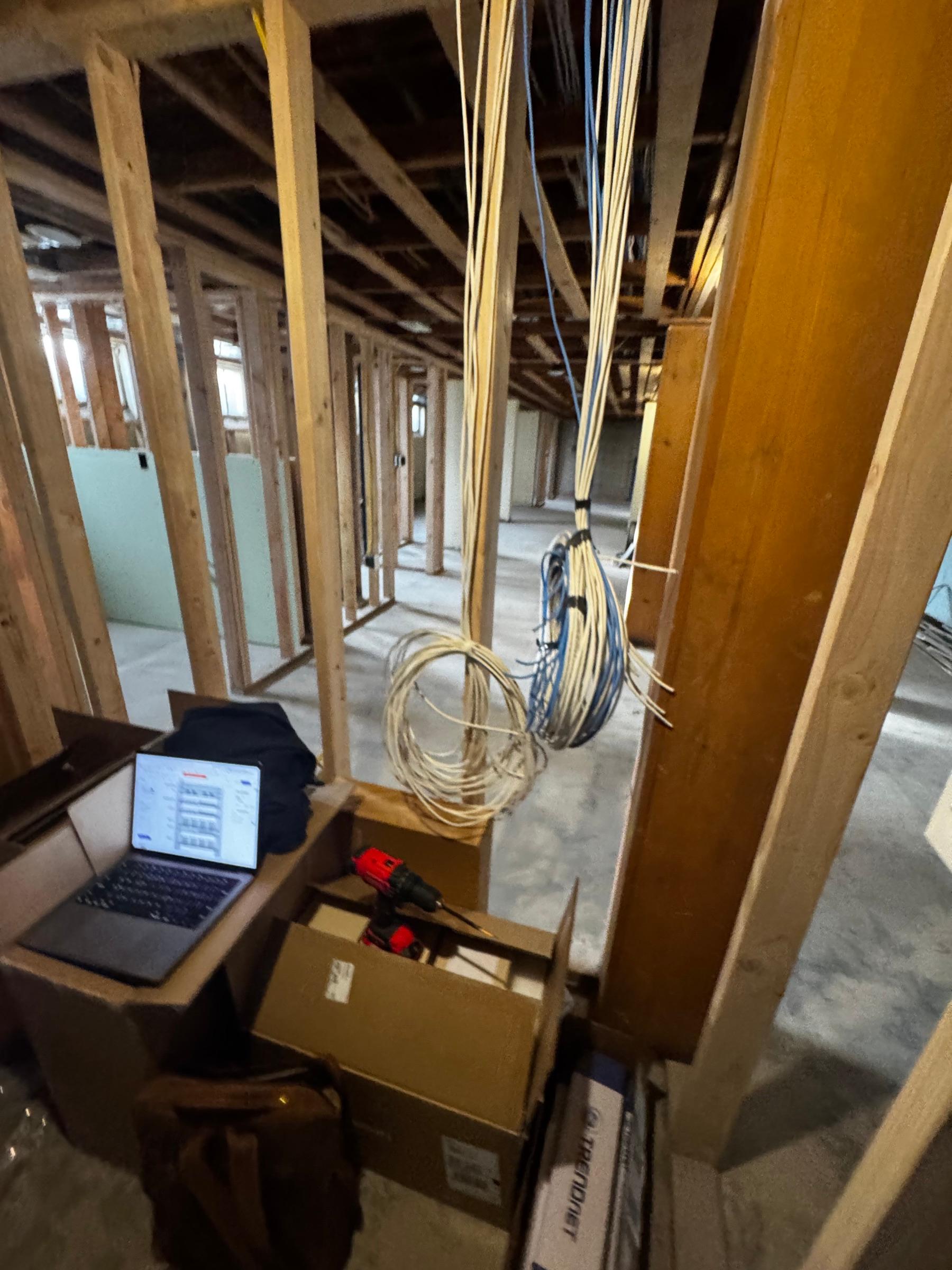 Low-voltage cable runs installed in an unfinished building under construction