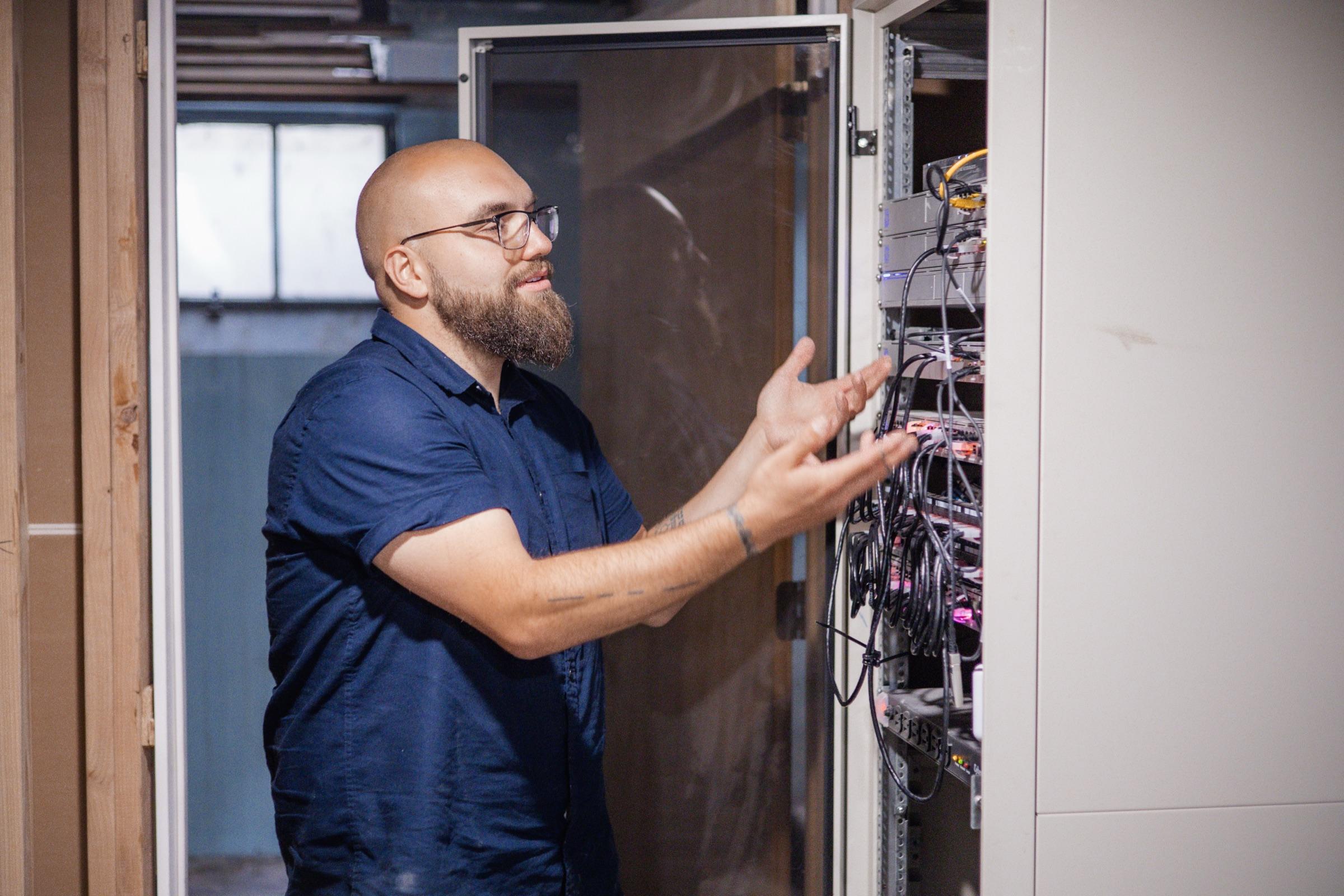 Kenton Batson, FinWell's founder, working inside an open server rack