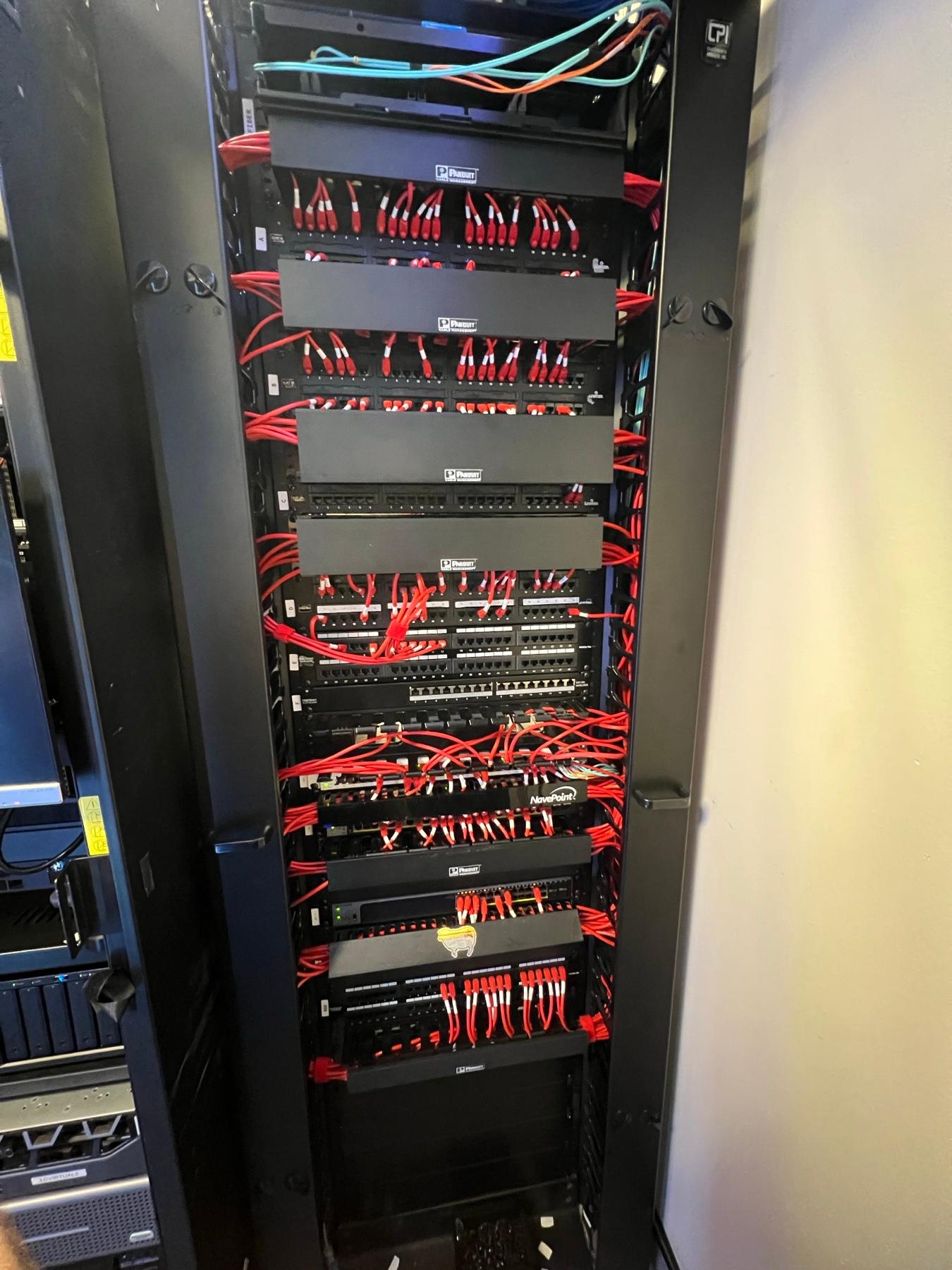 A fully wired network rack with fiber lines and patch panels