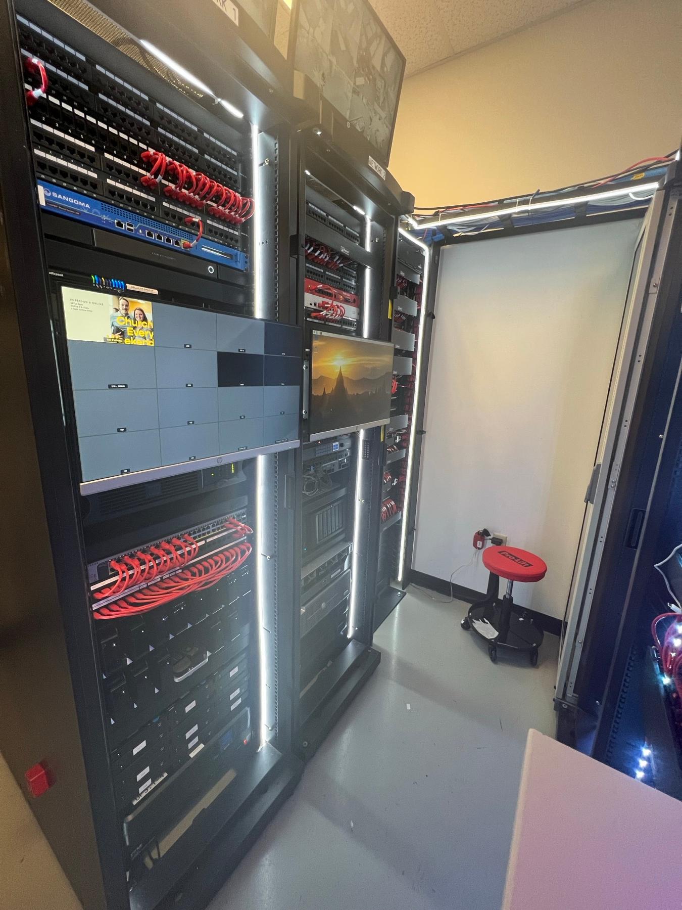 A fully built-out network server closet with labeled equipment racks