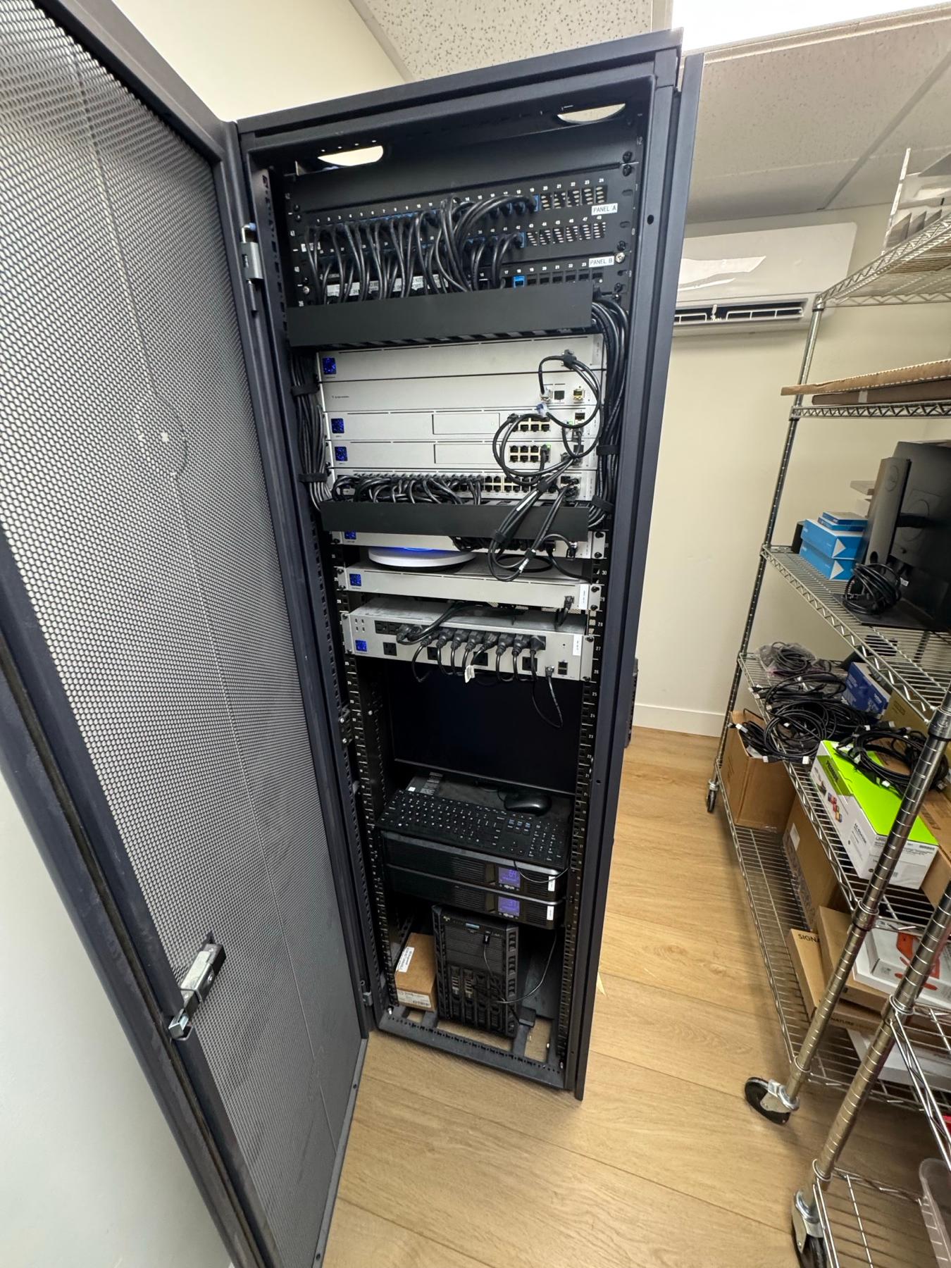 An open server rack cabinet with neatly organized cable management