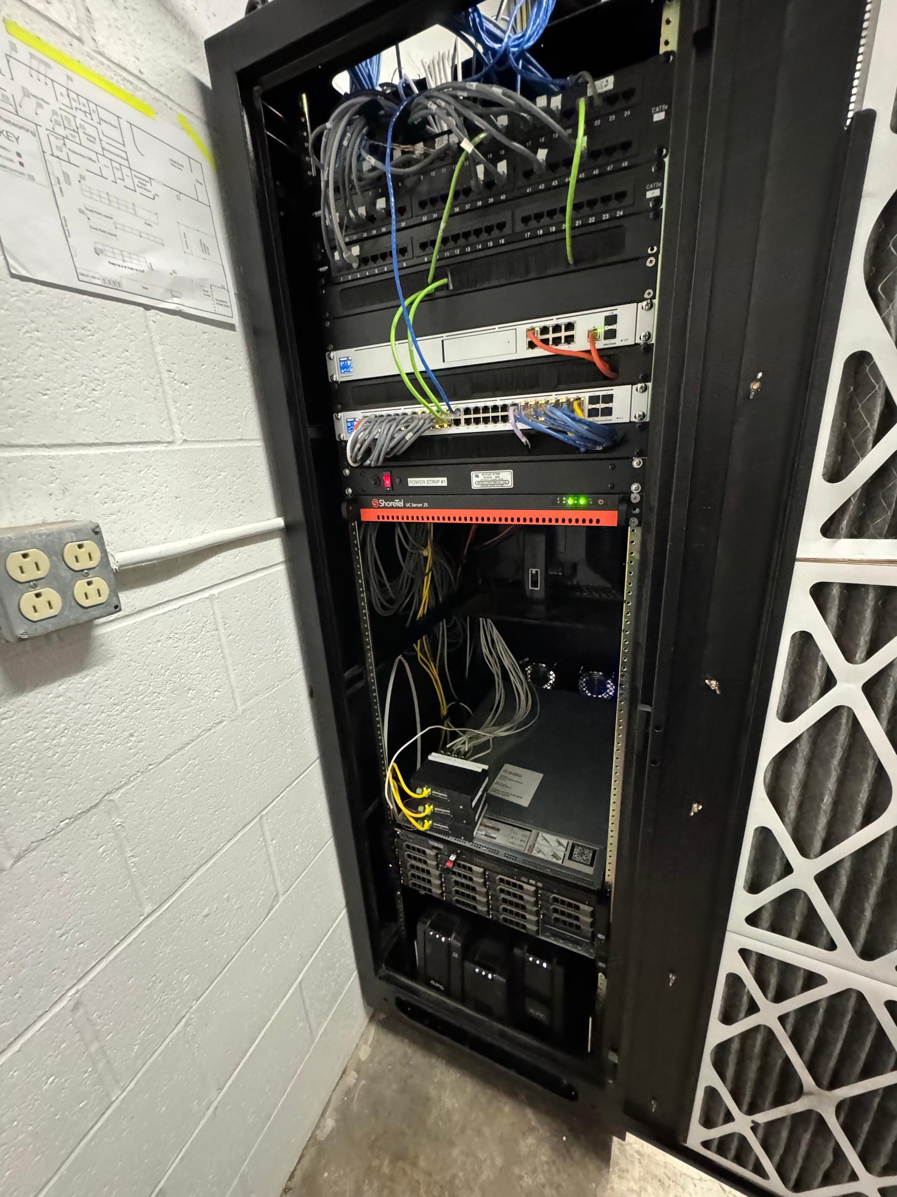 A network wiring closet with patch panels, switches, and rack-mounted server equipment